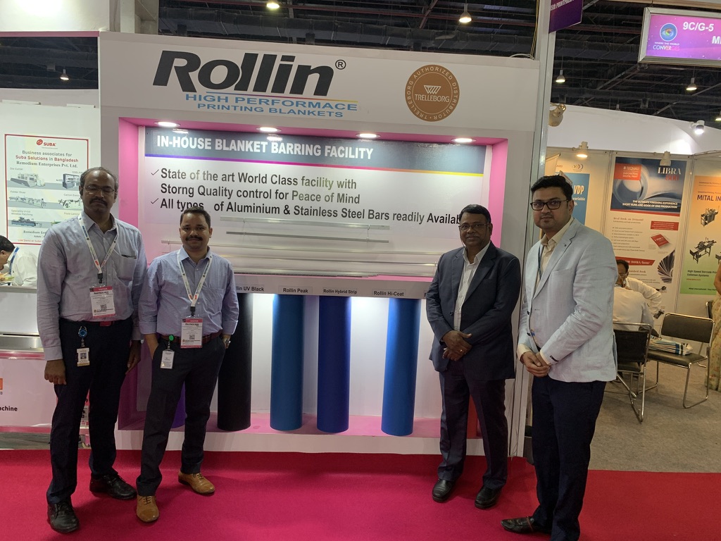 Remedium team and visitors beside Rollin offset printing blanket display at Print Pack India 2022